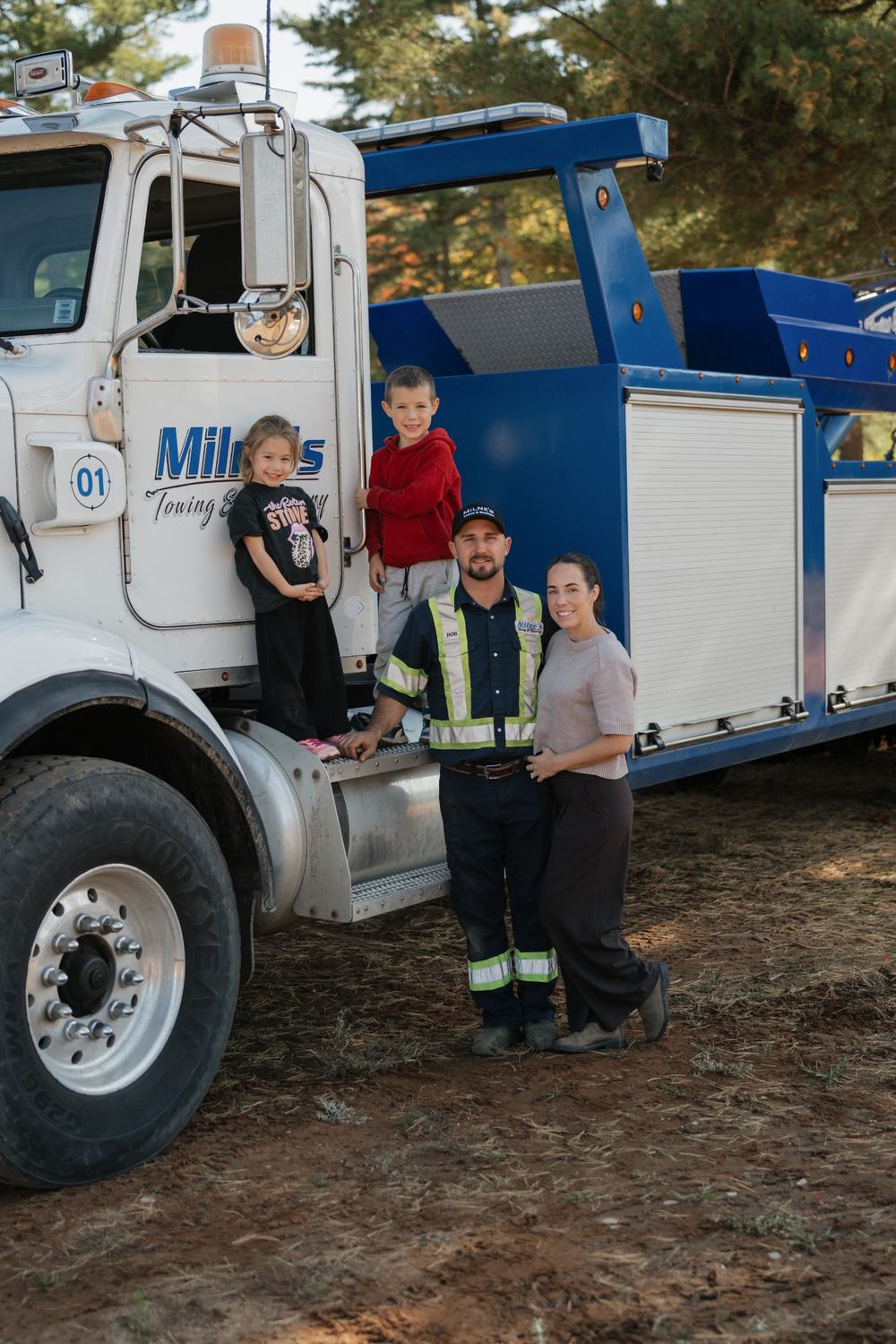 Rob with his family beside a Milne's recovery truck.